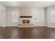 Cozy living room with a stone fireplace and hardwood floors, creating a warm and inviting atmosphere at 1840 Myrtle Island Dr, Las Vegas, NV 89117