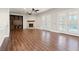 Spacious living room featuring a stone fireplace, ceiling fans, and access to the backyard through French doors at 1840 Myrtle Island Dr, Las Vegas, NV 89117