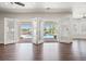 Bright living room with hardwood floors features folding doors open to a private pool at 1840 Myrtle Island Dr, Las Vegas, NV 89117