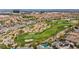 Aerial view of a community with a golf course featuring manicured greens and water features at 1994 Orchard Mist St, Las Vegas, NV 89135