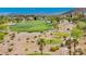 Overhead shot of a lush green golf course nestled between desert mountains and beautiful homes at 1994 Orchard Mist St, Las Vegas, NV 89135