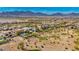 Expansive aerial view showcases the community, golf course, and stunning mountain backdrop at 1994 Orchard Mist St, Las Vegas, NV 89135
