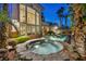 A luxurious backyard with a stone hot tub and patio with an exceptional view at 1994 Orchard Mist St, Las Vegas, NV 89135