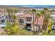 Stunning backyard featuring a pool, lush landscaping, a covered patio, and an upstairs balcony at 1994 Orchard Mist St, Las Vegas, NV 89135