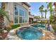 Beautiful backyard features a pool, spa, tall palm trees and a patio at 1994 Orchard Mist St, Las Vegas, NV 89135