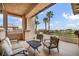 The home's balcony features palm trees in the background and seating for entertaining at 1994 Orchard Mist St, Las Vegas, NV 89135