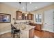Wet bar with granite countertops, custom cabinets, and barstool seating at 1994 Orchard Mist St, Las Vegas, NV 89135