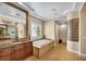 Luxurious bathroom featuring a soaking tub, glass block, and granite countertops at 1994 Orchard Mist St, Las Vegas, NV 89135