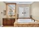 Bathroom boasts a jetted tub, custom cabinets, and neutral colors at 1994 Orchard Mist St, Las Vegas, NV 89135