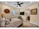 Neutral bedroom with a TV, view to ensuite, and large window at 1994 Orchard Mist St, Las Vegas, NV 89135