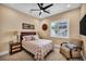Bedroom with decor, a queen sized bed, a fan, and an ensuite bathroom at 1994 Orchard Mist St, Las Vegas, NV 89135