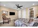Comfortable bedroom features a ceiling fan, TV, and easy bathroom access at 1994 Orchard Mist St, Las Vegas, NV 89135