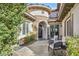 Charming courtyard with comfortable seating, stone accents, and an elegant arched doorway at 1994 Orchard Mist St, Las Vegas, NV 89135