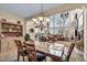 Bright dining room with high ceilings, chandelier, and views of the backyard patio and seating at 1994 Orchard Mist St, Las Vegas, NV 89135