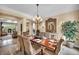 Inviting dining room featuring a chandelier, decorative mirror, and a view of the adjacent living area at 1994 Orchard Mist St, Las Vegas, NV 89135