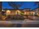 Beautiful two-story home displaying a well-manicured yard and a three-car garage with a tile roof at 1994 Orchard Mist St, Las Vegas, NV 89135
