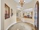Elegant foyer with marble flooring, decorative lighting, and arched openings into the living spaces at 1994 Orchard Mist St, Las Vegas, NV 89135