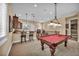This game room features a billiards table, bar seating, and staircase to the home's second floor at 1994 Orchard Mist St, Las Vegas, NV 89135