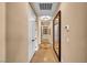 Hallway with tile flooring, decorative mirror, and arched doorway at 1994 Orchard Mist St, Las Vegas, NV 89135
