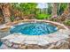 Relaxing hot tub is surrounded by stones and tropical landscaping at 1994 Orchard Mist St, Las Vegas, NV 89135