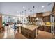 Open-concept kitchen with stainless steel appliances, granite island, and seamless flow into the adjacent living area at 1994 Orchard Mist St, Las Vegas, NV 89135