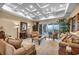 Elegant living room featuring a coffered ceiling, neutral decor, ample seating, and sliding doors to a patio at 1994 Orchard Mist St, Las Vegas, NV 89135