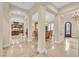 Open-concept living area with marble floors, decorative columns, and a view of the dining area at 1994 Orchard Mist St, Las Vegas, NV 89135