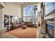 Bright living room with a fireplace, sliding glass doors, and comfortable leather seating area at 1994 Orchard Mist St, Las Vegas, NV 89135