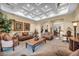 Cozy living room showcasing an elegant coffered ceiling and comfortable seating, perfect for relaxing or entertaining at 1994 Orchard Mist St, Las Vegas, NV 89135