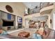Open-concept living room and kitchen with fireplace, balcony and comfortable seating at 1994 Orchard Mist St, Las Vegas, NV 89135