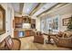 Charming living room with a beverage center, exposed wood beams, and comfortable seating area at 1994 Orchard Mist St, Las Vegas, NV 89135