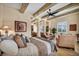 Beautiful main bedroom with exposed wood beams, and comfortable seating area at 1994 Orchard Mist St, Las Vegas, NV 89135
