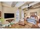 Stunning main bedroom with exposed wood beams, a ceiling fan, and a TV for your enjoyment at 1994 Orchard Mist St, Las Vegas, NV 89135