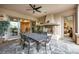 Outdoor dining area with fireplace and ceiling fan for comfortable outdoor entertaining at 1994 Orchard Mist St, Las Vegas, NV 89135