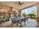 Covered patio with stone fireplace, ceiling fan, and outdoor dining set, ideal for outdoor relaxation and entertaining at 1994 Orchard Mist St, Las Vegas, NV 89135