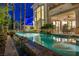 Enjoy a refreshing pool with rock accents, lush landscaping, and waterfall features in this beautiful backyard at 1994 Orchard Mist St, Las Vegas, NV 89135