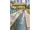 Beautiful backyard pool with a waterfall feature and a covered cabana for relaxing outdoors at 1994 Orchard Mist St, Las Vegas, NV 89135