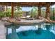 Poolside BBQ grill is built into the deck and covered by a tiki hut at 1994 Orchard Mist St, Las Vegas, NV 89135