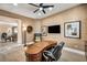 Comfortable study with a large desk, textured wallpaper, and a view of the adjacent dining area at 1994 Orchard Mist St, Las Vegas, NV 89135