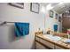 Standard bathroom with a single sink vanity, mirror, and a blue hand towel at 2080 Karen Ave # 9, Las Vegas, NV 89169