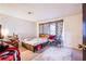 Modest bedroom featuring a simple bed frame and a window with patterned curtains at 2080 Karen Ave # 9, Las Vegas, NV 89169