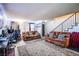 Bright living room with cozy sofas, a patterned rug, and a staircase leading to the upper level at 2080 Karen Ave # 9, Las Vegas, NV 89169