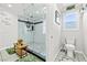 Bathroom featuring walk in shower with glass, a toilet, and natural light at 2127 Brewer Ave, North Las Vegas, NV 89081