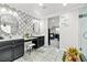 Spacious bathroom featuring dual sinks, dark cabinetry, walk in shower, and tile flooring at 2127 Brewer Ave, North Las Vegas, NV 89081