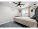 Bright bedroom featuring plush carpet, a queen bed, and views of the city skyline at 2127 Brewer Ave, North Las Vegas, NV 89081
