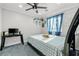 Bedroom with blue bedding and curtains plus desk and tv set at 2127 Brewer Ave, North Las Vegas, NV 89081