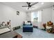 Cozy bedroom area with chair and natural light from the bright window at 2127 Brewer Ave, North Las Vegas, NV 89081