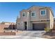 Charming two-story home with desert landscaping, brick accents and an attached two-car garage at 2127 Brewer Ave, North Las Vegas, NV 89081