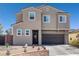Two-story home featuring desert landscaping, a brick-lined yard, and a two-car garage at 2127 Brewer Ave, North Las Vegas, NV 89081