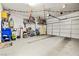 Large garage with overhead door, storage shelves, water heater, and room for two cars at 2127 Brewer Ave, North Las Vegas, NV 89081
